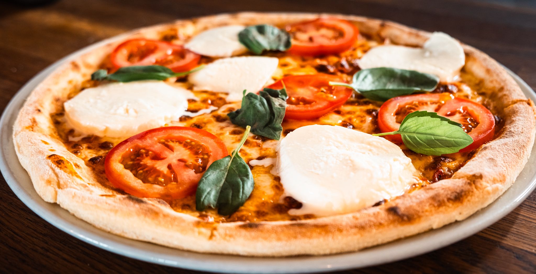 Pizza with fresh tomato, buffalo mozzarella and basil